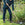 Person gardening with a Bulldog dutch hoe in a lush green garden