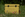 Yellow tin labeled 'Seeds' with floral designs on grass