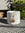 Decorative white pot with gold bow and star on a wicker surface