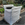 Large white bag filled with soil on a wooden pallet in a vegetable garden.