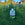 Lawn feed bottle on grass with yellow flowers and a clear blue sky