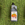 Bottle of plant food on grass background