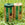 Two rolls of green and brown garden twine on grass with  packaging.
