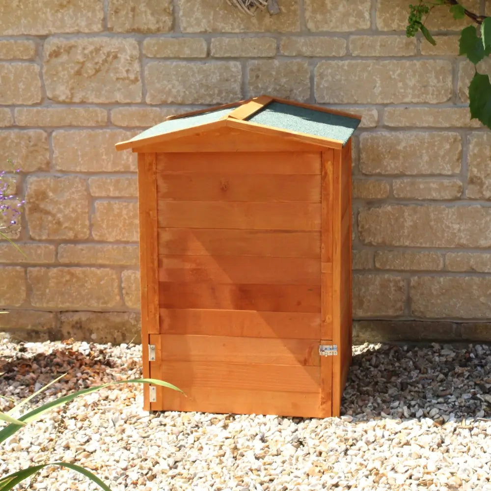 Wooden bee hive against a stone wall