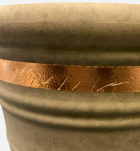 Ceramic planter with a copper band on a white background