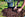 Person planting a tree with hands in soil, bucket nearby on grass