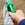 Man holding a green spray nozzle attachment