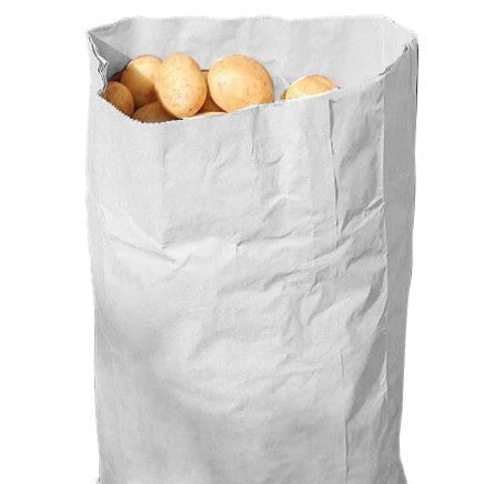 White paper bag filled with potatoes on a white background